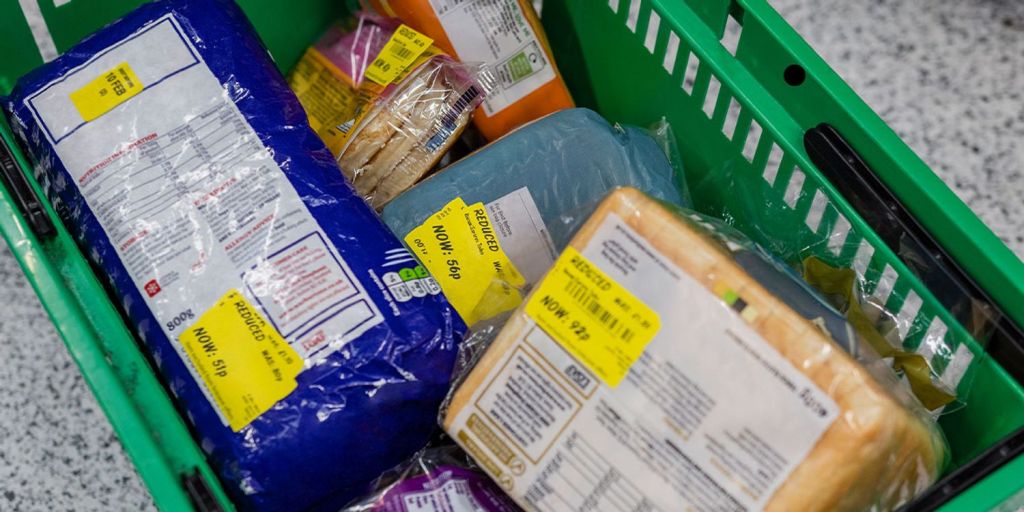 An ASDA basket full of yellow sticker reduced items.